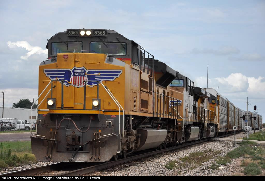 Westbound vehicle train comes out of the siding